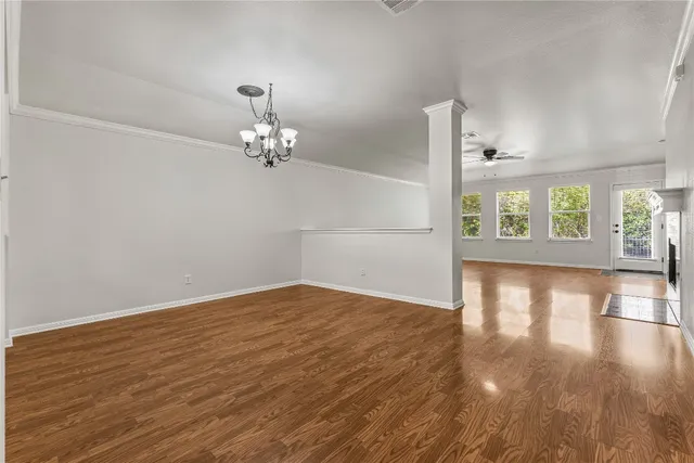 wooden floor in an empty room with a window