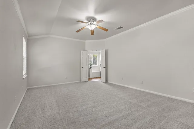 a view of an empty room with a fan