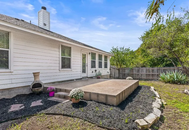 a view of a backyard with sitting area