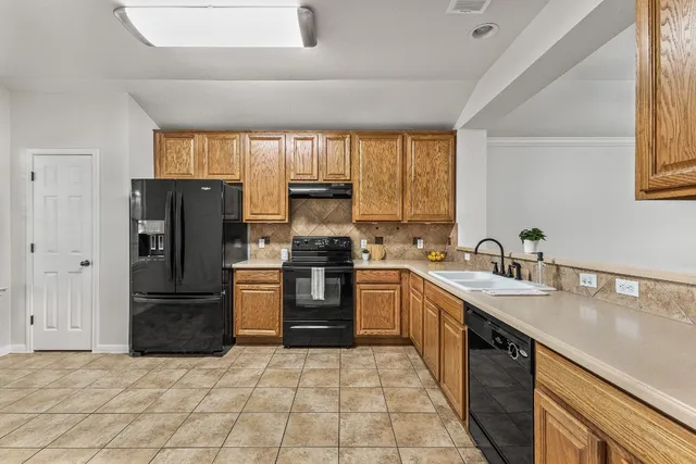 a kitchen with a refrigerator sink and stove