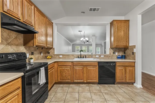 a kitchen with a sink and cabinets