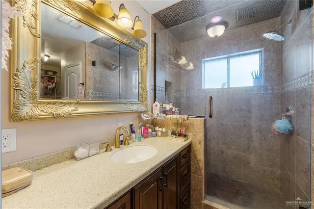 a bathroom with a granite countertop sink mirror and a