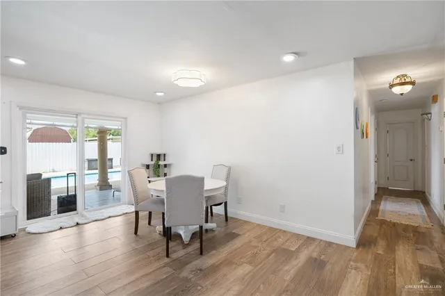 a view of a dining room with furniture and wooden floor