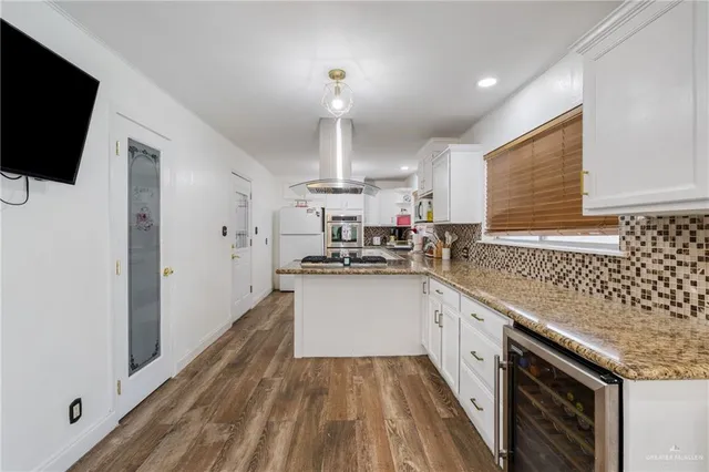 a kitchen with a sink dishwasher a stove and a microwave oven with cabinets