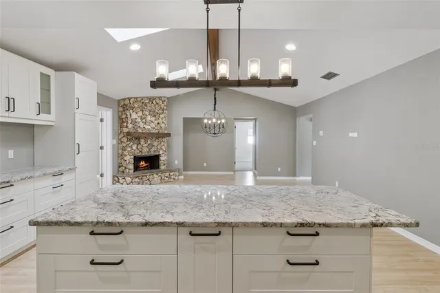 an empty room with a window and ceiling fan