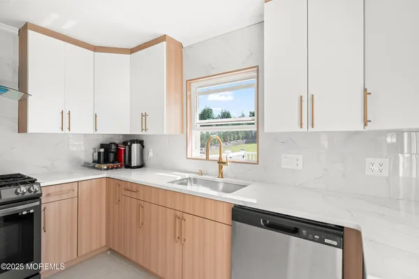 a kitchen with a sink cabinets and window