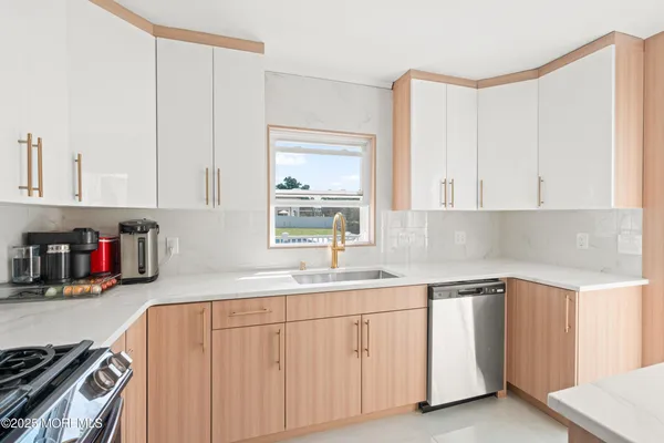 a kitchen with granite countertop white cabinets and sink