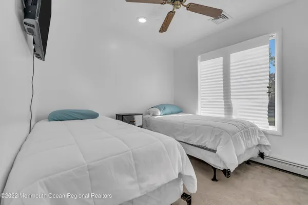 a bedroom with two beds and painted walls