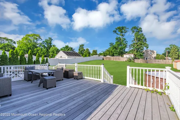 a view of a deck with chairs and wooden floor
