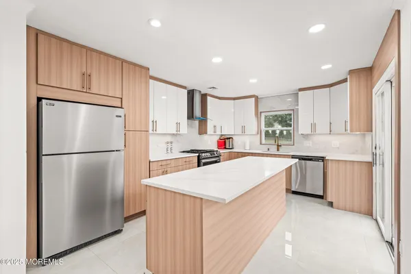 a kitchen with a refrigerator a sink and cabinets