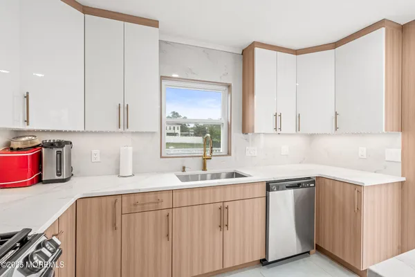 a kitchen with sink cabinets and window
