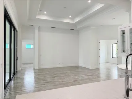 a view of a room with wooden floor and door