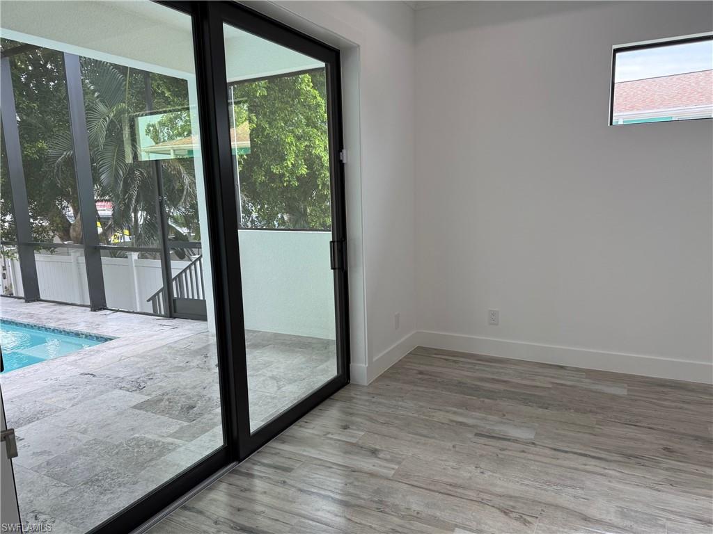 82 Tahiti Road Marco Island, FL 34145 - Photo 17 of 27 a view of a room with wooden floor and door