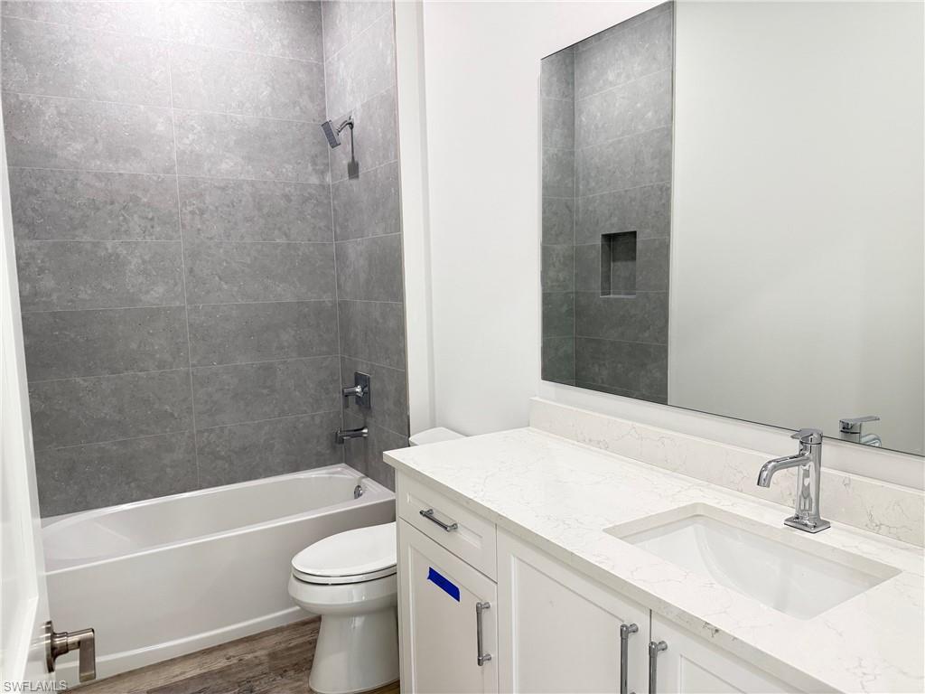 82 Tahiti Road Marco Island, FL 34145 - Photo 22 of 27 a bathroom with a sink a toilet and shower