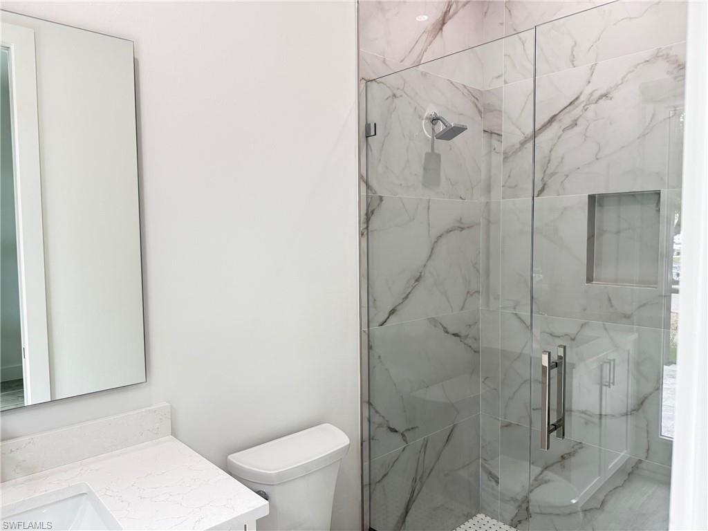 82 Tahiti Road Marco Island, FL 34145 - Photo 23 of 27 a bathroom with a toilet and shower