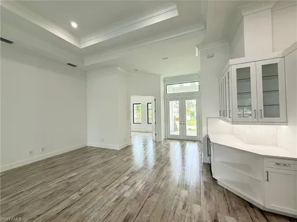 a kitchen with kitchen island a counter top a refrigerator and a sink
