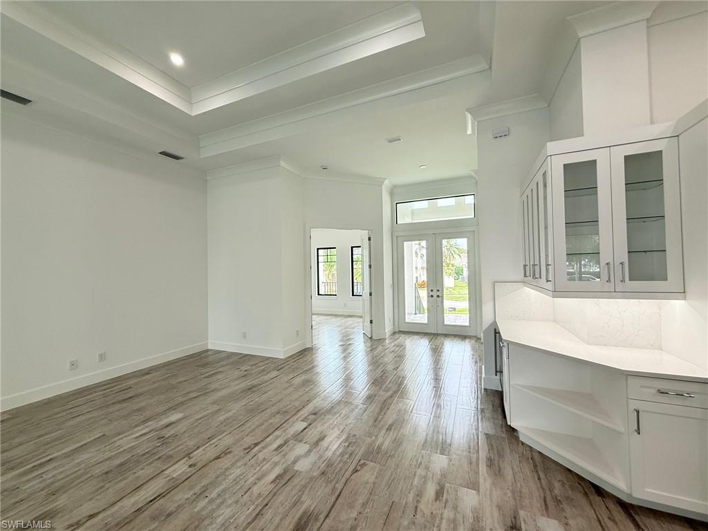 82 Tahiti Road Marco Island, FL 34145 - Photo 8 of 27 a hallway with wooden floors and cabinet