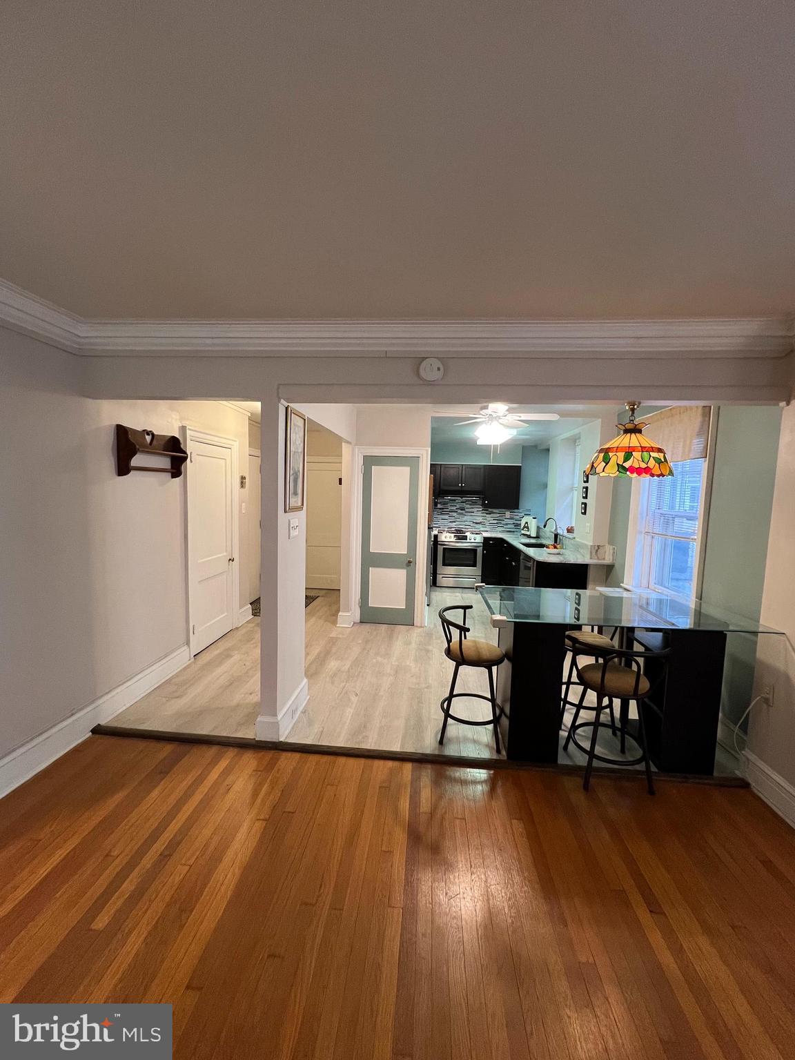 4643 Pine Street, Unit C411 Philadelphia, PA 19143 - Photo 1 of 63 a view of a workspace with furniture and wooden floor
