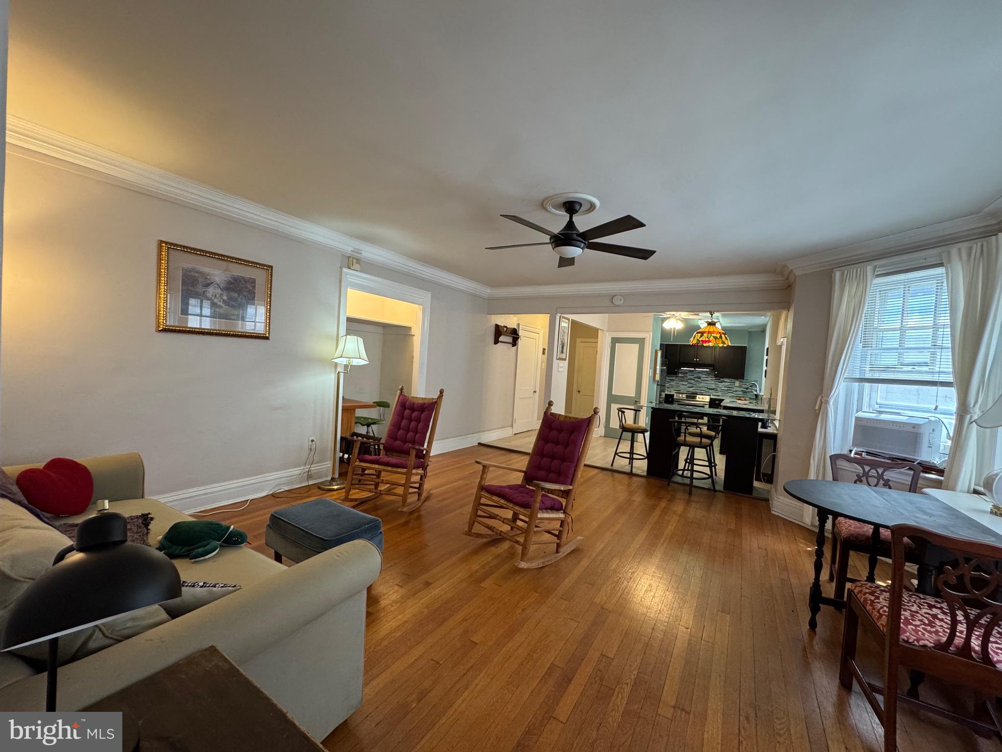 4643 Pine Street, Unit C411 Philadelphia, PA 19143 - Photo 23 of 63 a living room with furniture and a flat screen tv