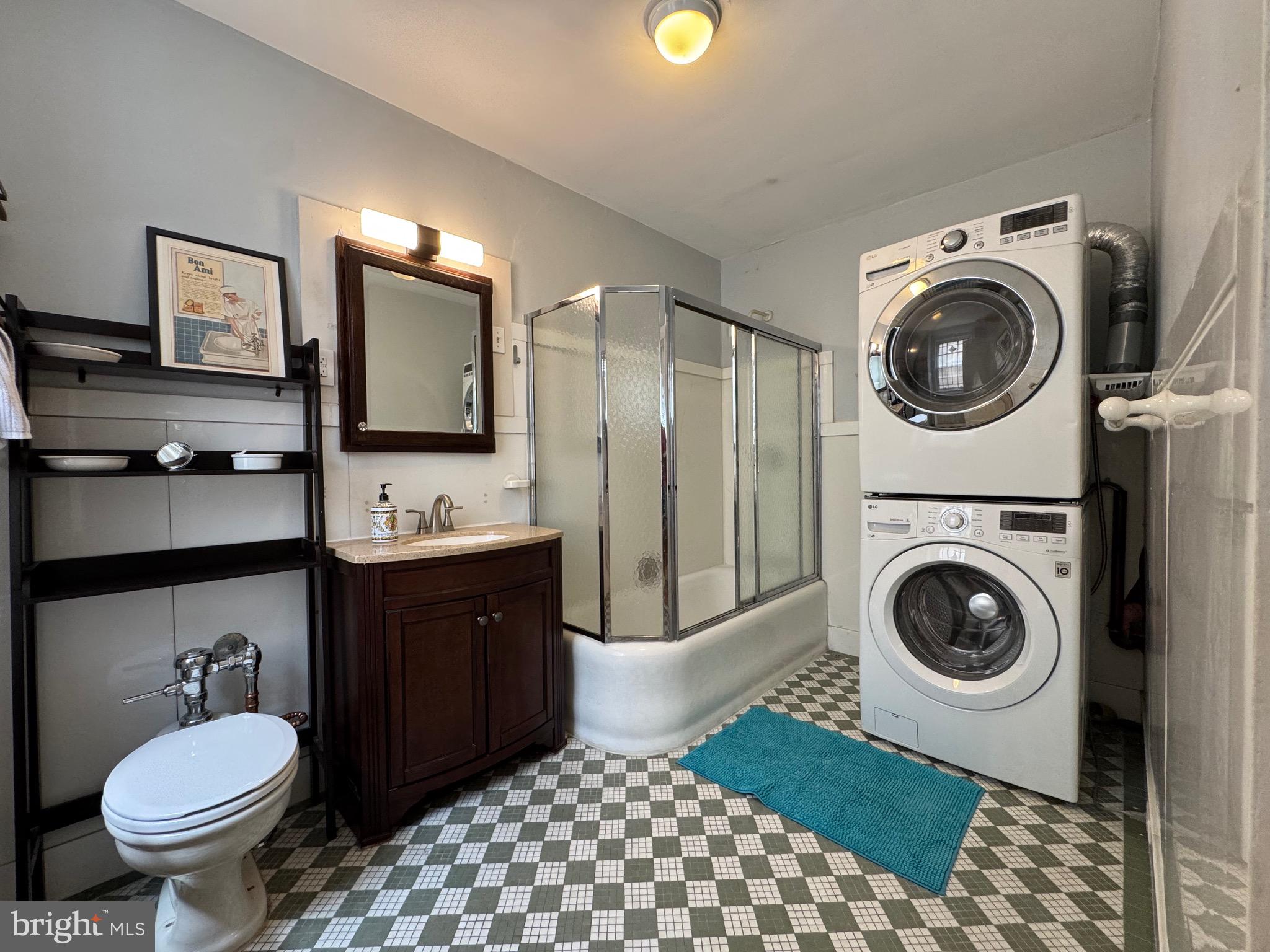 4643 Pine Street, Unit C411 Philadelphia, PA 19143 - Photo 35 of 60 a bathroom with a toilet sink and mirror
