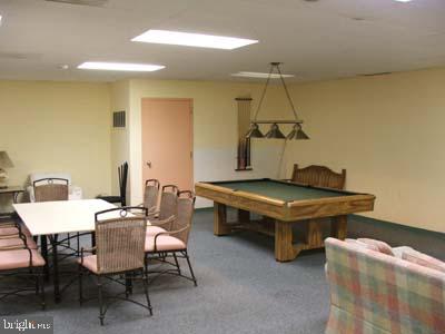 4643 Pine Street, Unit C411 Philadelphia, PA 19143 - Photo 48 of 63 a living room with a table chairs and a table