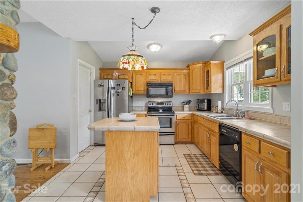 308 Kiser Road Bessemer City, NC 28016 - Photo 11 of 32 a kitchen with stainless steel appliances granite countertop a sink a stove and a refrigerator