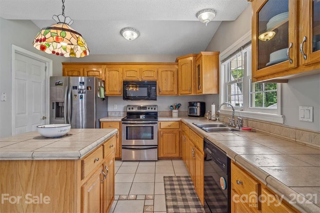 308 Kiser Road Bessemer City, NC 28016 - Photo 13 of 32 a kitchen with stainless steel appliances granite countertop a sink stove and refrigerator