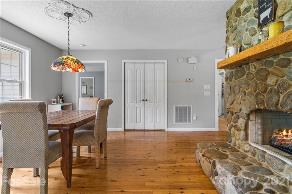 308 Kiser Road Bessemer City, NC 28016 - Photo 17 of 32 a dining room with furniture a chandelier and wooden floor