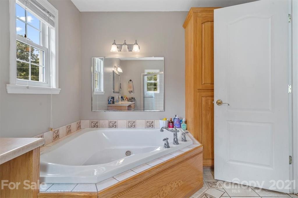 308 Kiser Road Bessemer City, NC 28016 - Photo 21 of 32 a bath tub sitting next to a bathroom sink