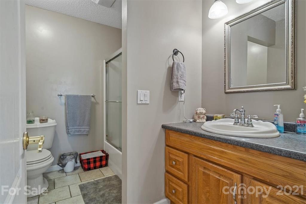 308 Kiser Road Bessemer City, NC 28016 - Photo 23 of 32 a bathroom with a granite countertop sink toilet and shower