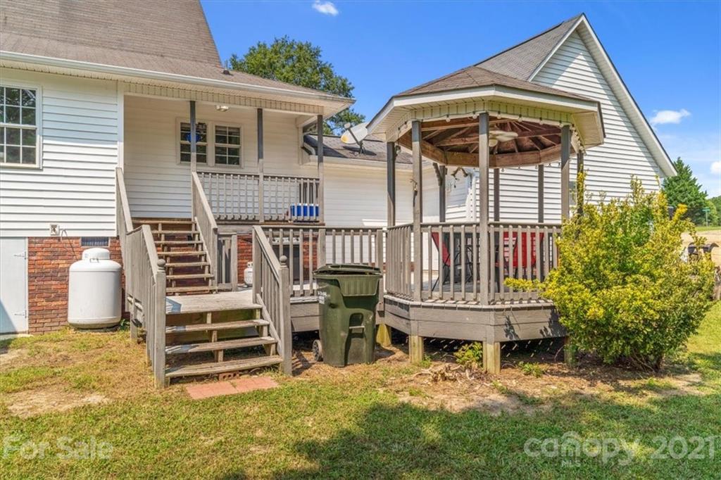 308 Kiser Road Bessemer City, NC 28016 - Photo 26 of 32 a view of a house with a small deck and a yard