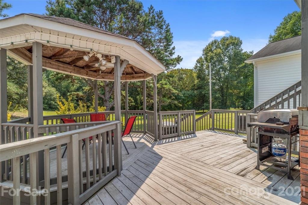 308 Kiser Road Bessemer City, NC 28016 - Photo 27 of 32 a view of a deck with two chair and wooden floor