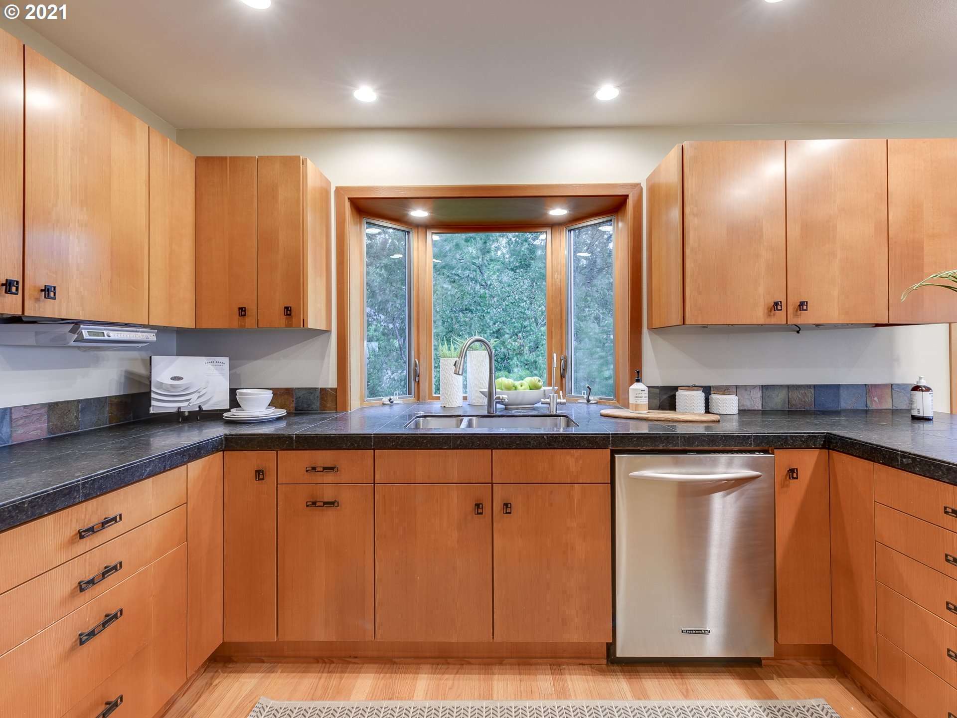 3630 Southwest Patton Road Portland, OR 97221 - Photo 11 of 29 a kitchen with wooden cabinets a sink a window and stainless steel appliances