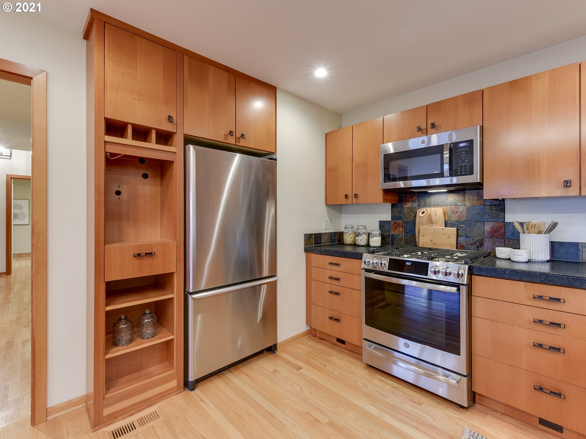 3630 Southwest Patton Road Portland, OR 97221 - Photo 10 of 29 a kitchen with granite countertop wooden cabinets and stainless steel appliances
