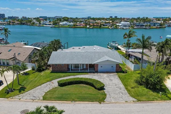 an aerial view of a house with outdoor space and lake view