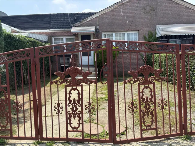 a view of a house with a iron gate