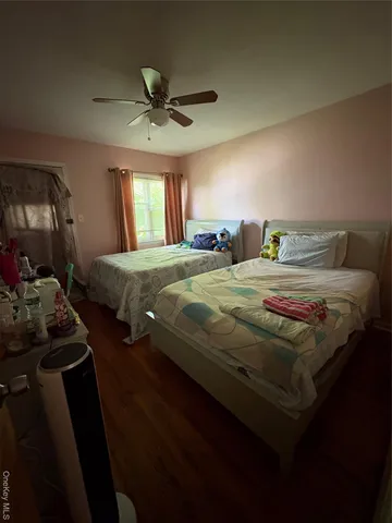 a bedroom with double bed and a window