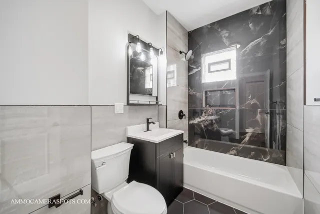 a bathroom with a toilet a sink and bathtub