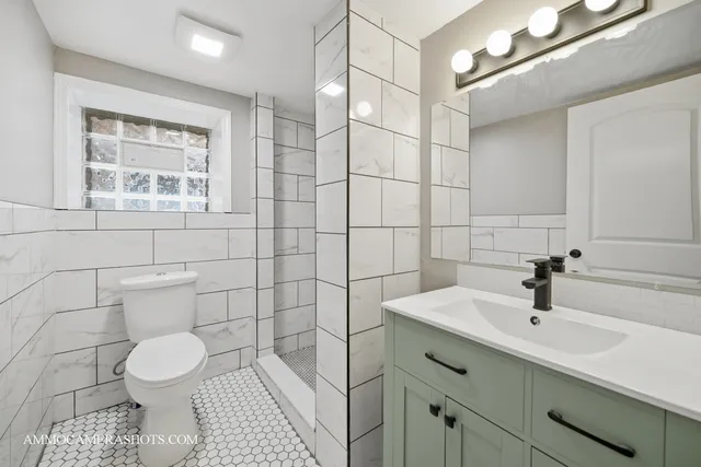 a bathroom with a sink toilet and shower