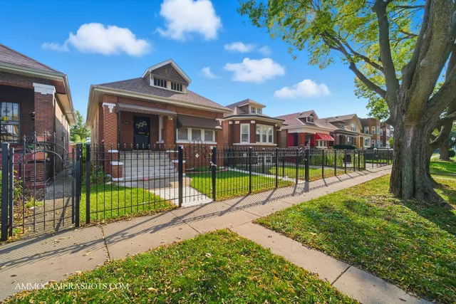 a view of a house with a yard and a patio