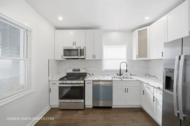 a kitchen with a refrigerator sink and cabinets