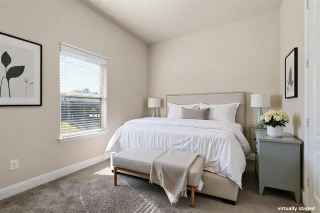 a bedroom with a bed and a couch