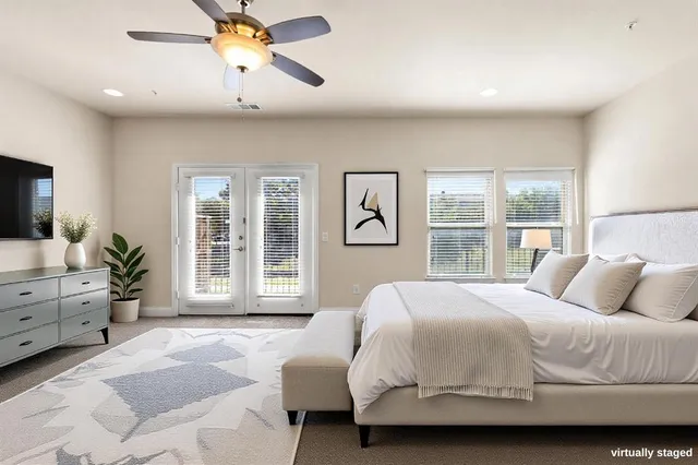 a bedroom with a large bed and a window