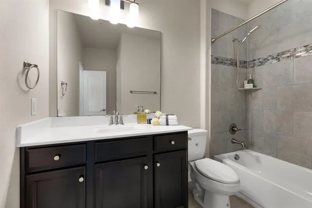 a bathroom with a sink toilet tub and shower