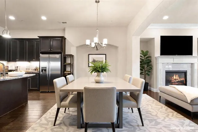 a dining room with furniture a flat screen tv and a chandelier