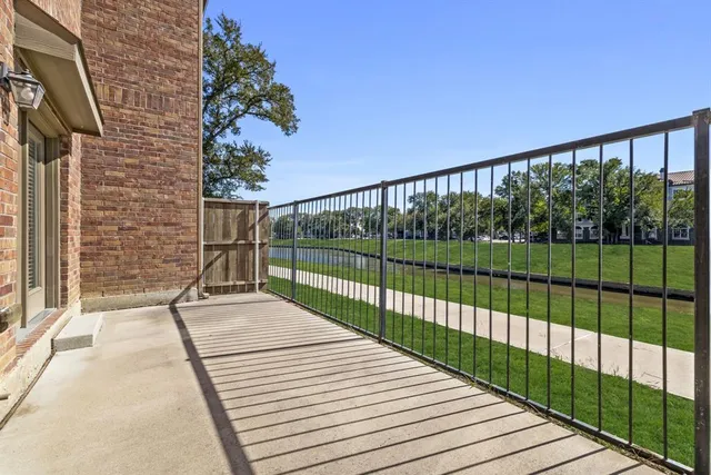 a view of balcony with wooden floor and fence