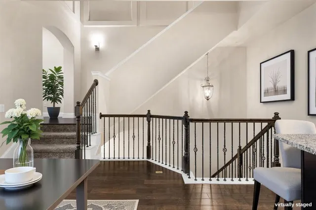 a view of a hallway with wooden floor and a potted plant
