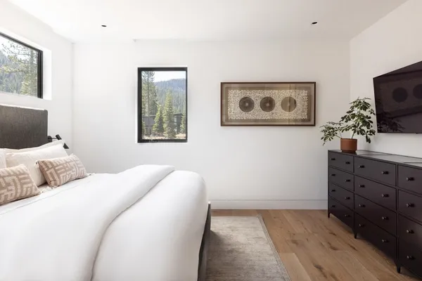 a bedroom with bed and wooden floor
