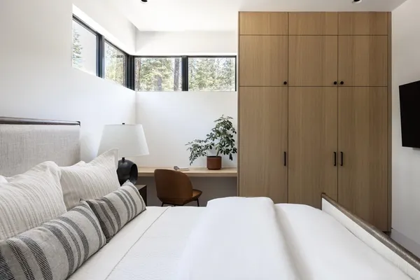 a bedroom with a large bed and a tv