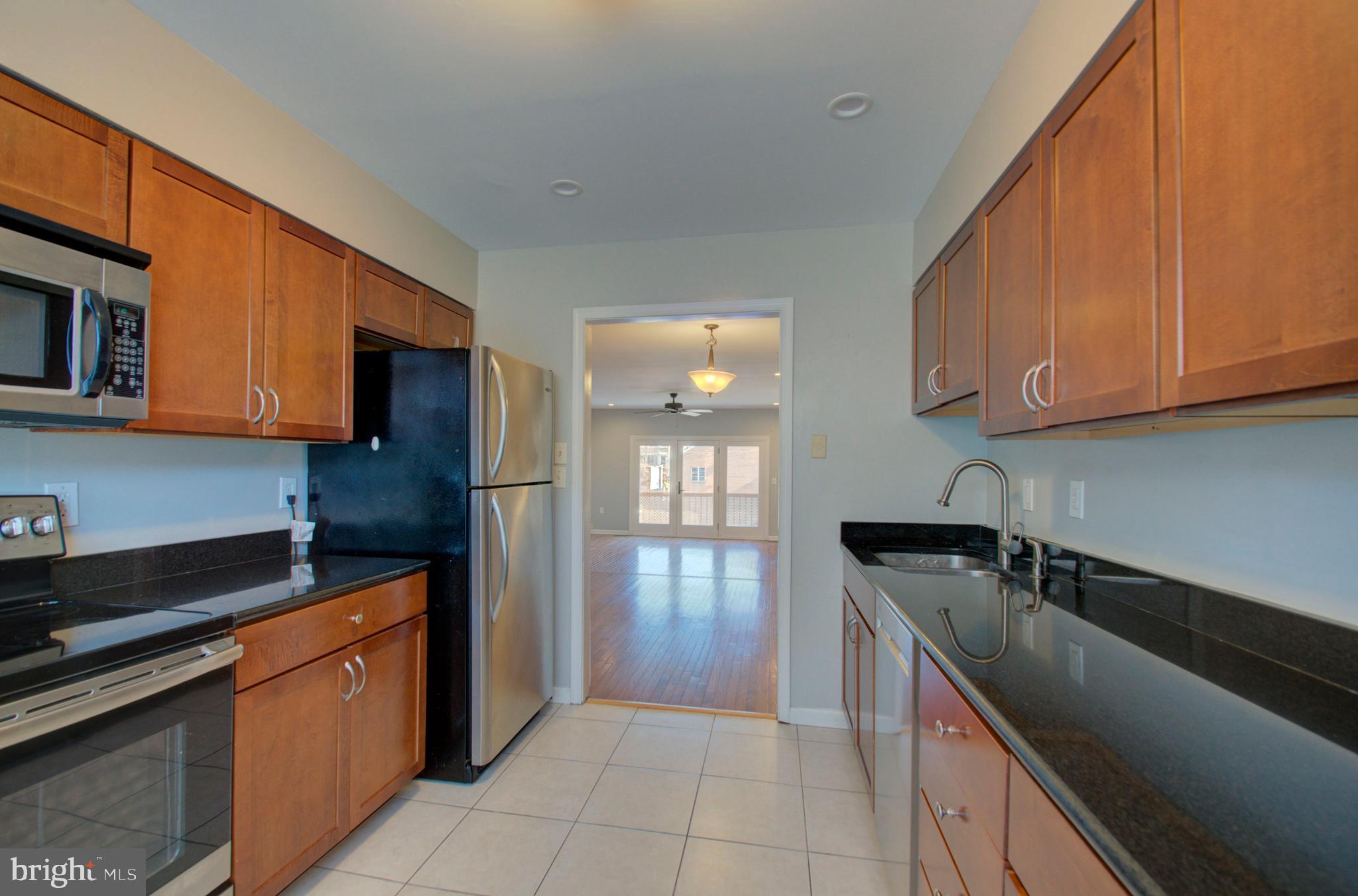 1159 5th Street Northeast Washington, DC 20002 - Photo 9 of 43 Kitchen with black granite countertops